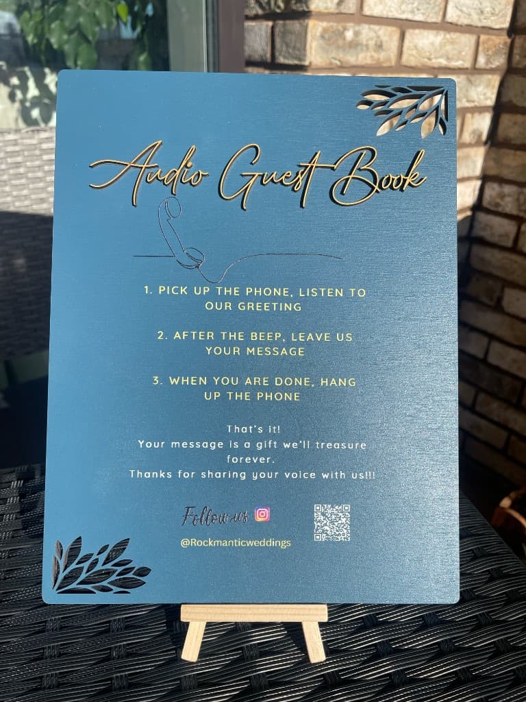 A teal and gold Audio Guest Book instruction sign